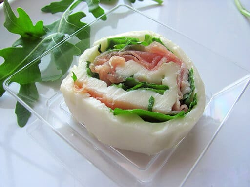 Rolls of mozzarella and raw ham