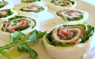 Rolls of mozzarella and raw ham